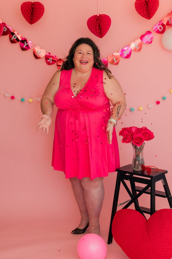 plus size model Tish Lee in pink dress throwing confetti