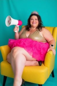 middle aged woman Tish Lee pink tutu, megaphone, tiara on head
